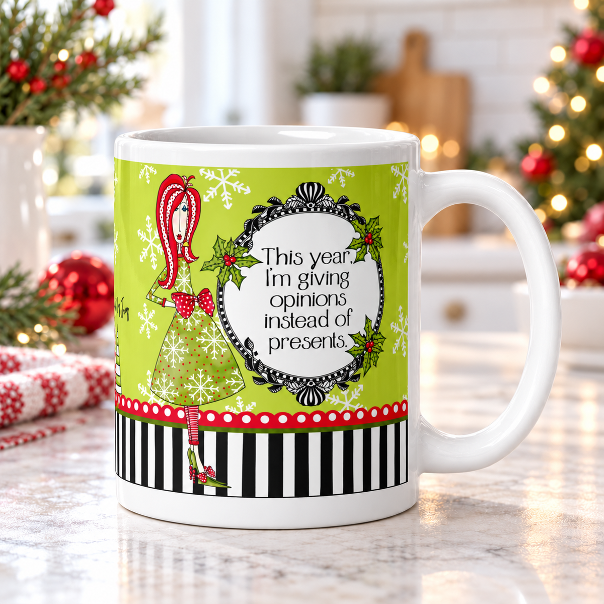 Dolly Mama “This year, I’m giving opinions instead of presents” mug on a bright kitchen counter, handle right, with Christmas greenery and red ornaments.