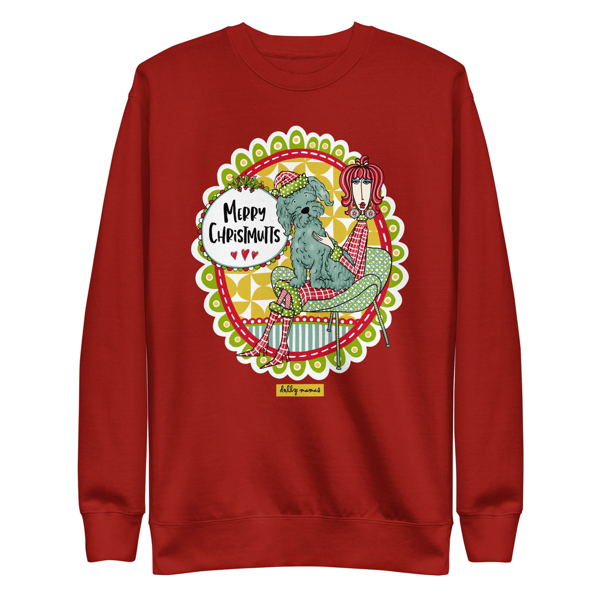 Front view of a cardinal red crewneck sweatshirt featuring Dolly Mamas artwork of a woman with a dog on her lap and the words “Merry Christmutts.”
